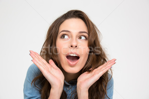 Closeup of surprised pretty young woman  Stock photo © deandrobot