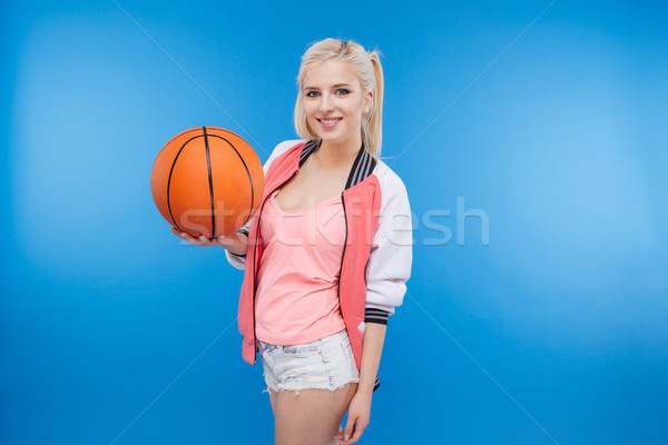 Female teenager holding basketball ball Stock photo © deandrobot