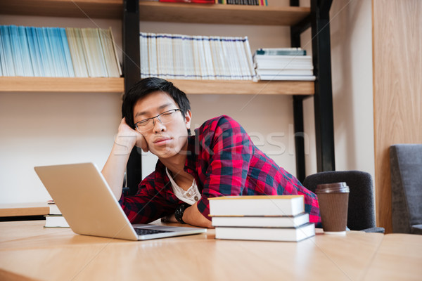 Man sleeping at the library near laptop and books Stock photo © deandrobot