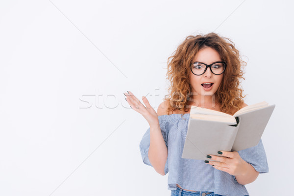 Woman in singlet and glasses reading book Stock photo © deandrobot