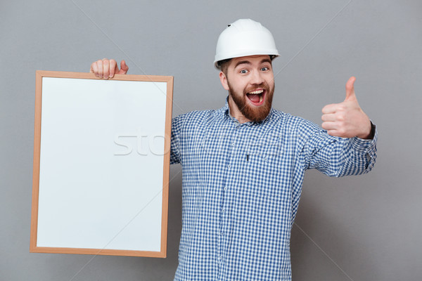 Heiter bärtigen Builder halten Kopie Raum Bord Stock foto © deandrobot