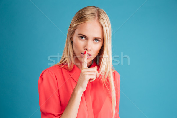 Potrait of attractive young woman showing silence gesture Stock photo © deandrobot