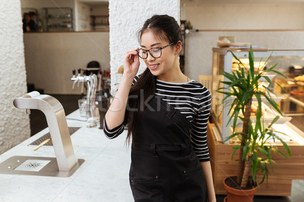 Young Asian barmaid in eyeglasses Stock photo © deandrobot