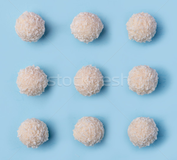 Stock photo: Coconut sweeties candy over blue table background.