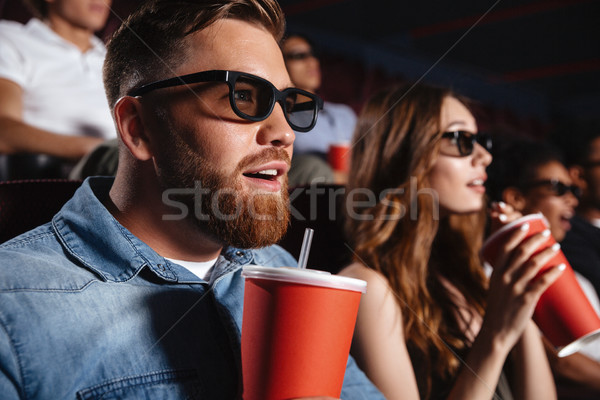 Concentrated loving couple friends sitting in cinema Stock photo © deandrobot