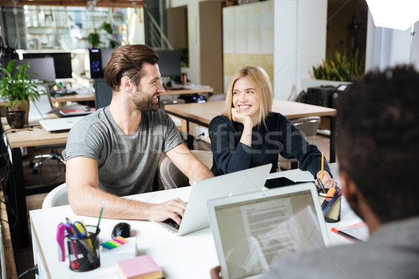 Happy young colleagues sitting in office coworking Stock photo © deandrobot