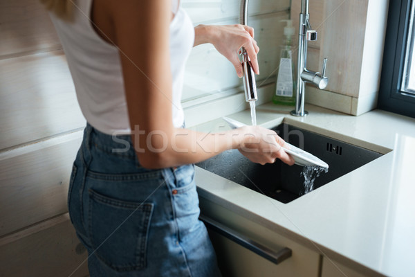 Kép nő mosogatás áll konyha hátulnézet Stock fotó © deandrobot