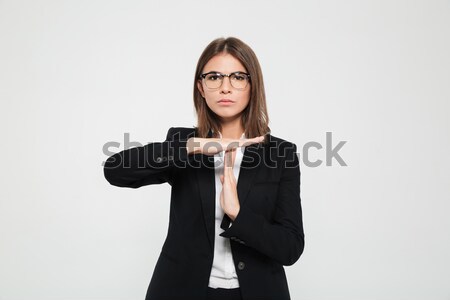 Portrait of a serious young businesswoman in eyeglasses Stock photo © deandrobot