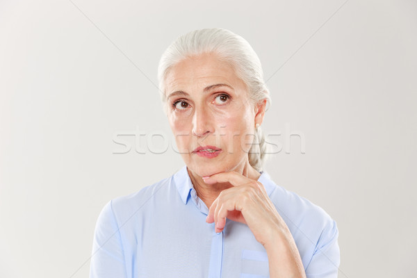 Close-up of thinking beautiful old woman in blue shirt, looking  Stock photo © deandrobot