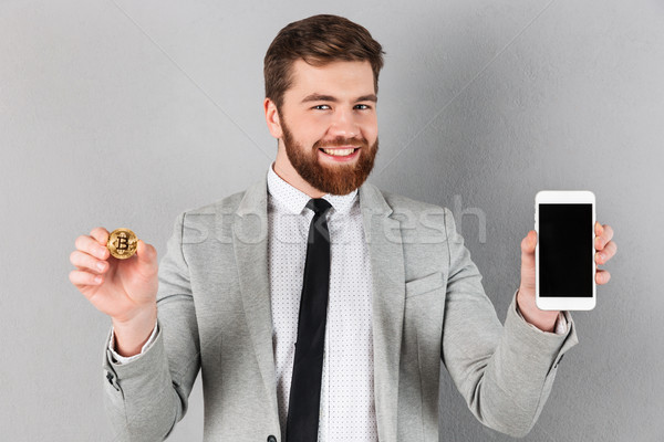 Portré derűs üzletember tart bitcoin mutat Stock fotó © deandrobot