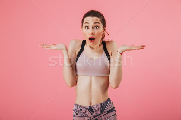 Surprised sportswoman shrugs her shoulders and looking at the camera Stock photo © deandrobot
