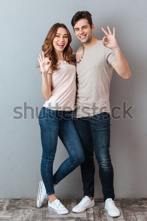 Full length portrait of two cheerful young women Stock photo © deandrobot