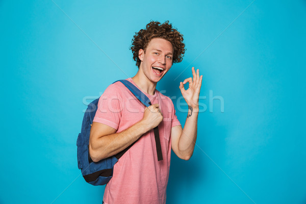 Image of student guy with curly hair wearing casual clothing and Stock photo © deandrobot