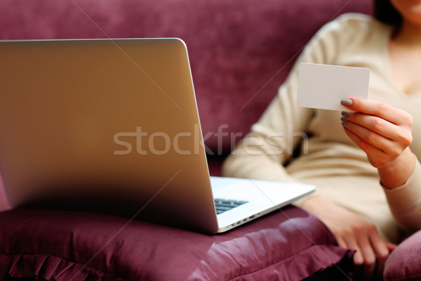 Young woman doing online shopping with blank credit card Stock photo © deandrobot