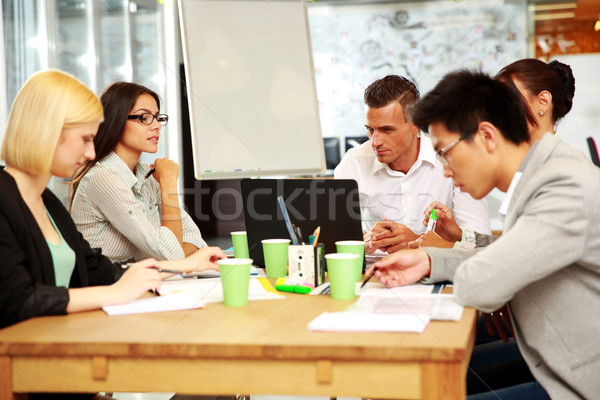 Business people having meeting around table in office Stock photo © deandrobot