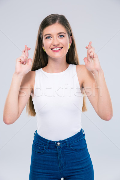 Female teenager showing gesture with crossed fingers  Stock photo © deandrobot