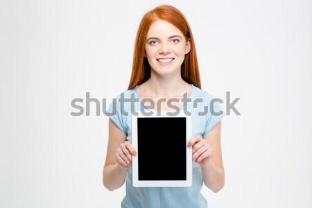 Redhead woman showing blank tablet computer screen Stock photo © deandrobot