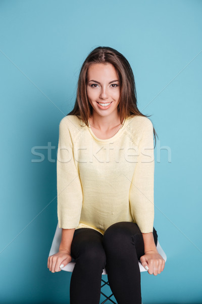 Close-up portrait of a smiling girl sitting on chair Stock photo © deandrobot