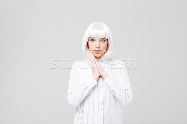 Beautiful smiling young woman in blonde wig and shirt Stock photo © deandrobot