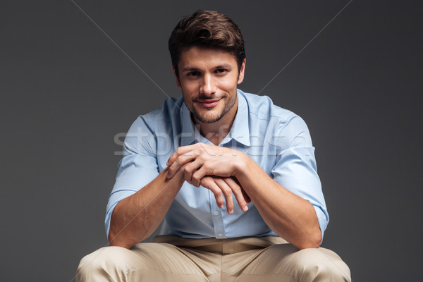 Close up portrait of a man in blue shirt sitting Stock photo © deandrobot