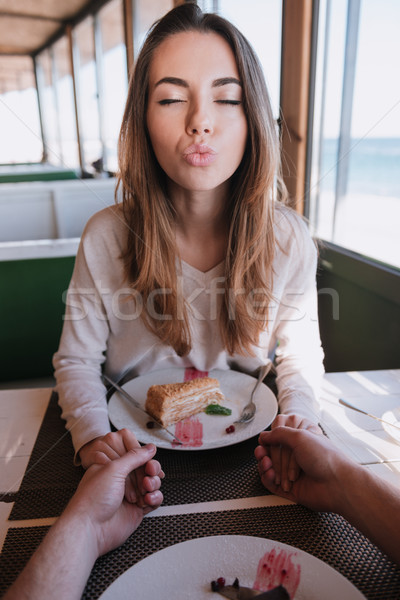 Verical image of woman on date sands air kiss Stock photo © deandrobot