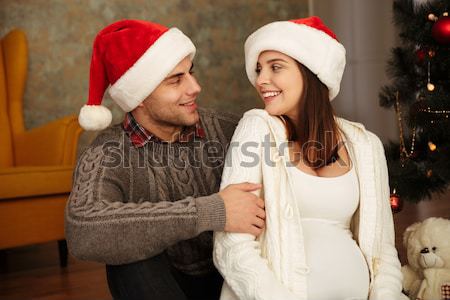 Friends in santa's hats with phones Stock photo © deandrobot