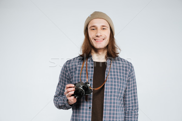 Smiling Hipster with retro camera Stock photo © deandrobot