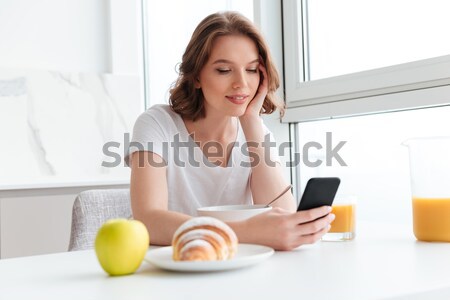 Happy pregnant young woman using blank screen laptop on sofa Stock photo © deandrobot