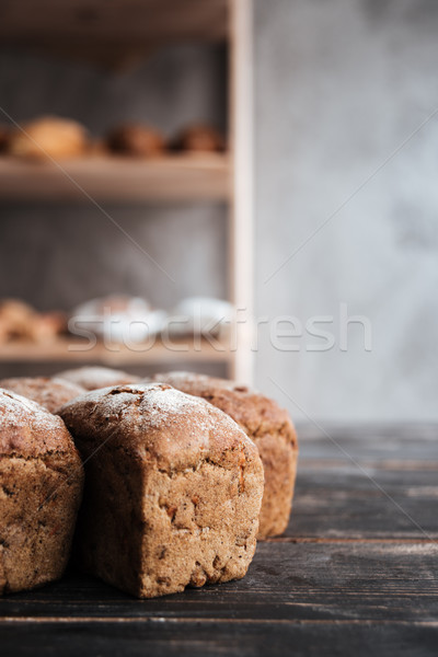 Bread with flour on dark wooden table Stock photo © deandrobot