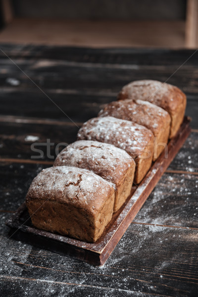 Stock photo: Bread with flour on dark wooden table
