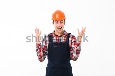 Portrait of a satisfied young male builder celebrating Stock photo © deandrobot