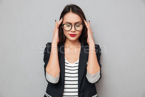 Imagen confundirse Asia mujer de negocios dolor de cabeza Foto stock © deandrobot