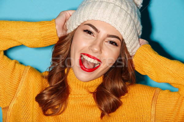 Close up portrait of pretty cheerful girl in winter hat Stock photo © deandrobot