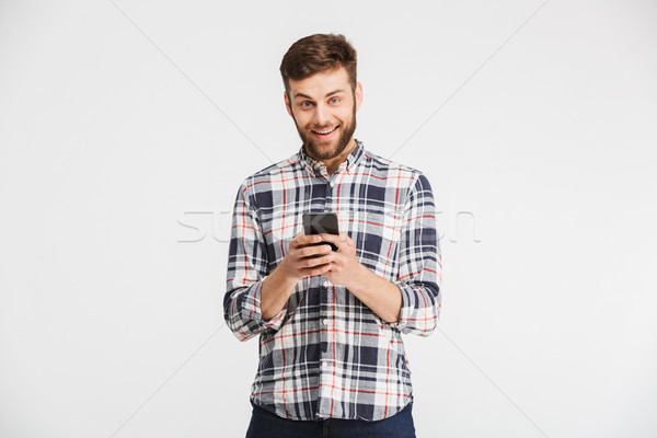 Portrait of a smiling young man in plaid shirt Stock photo © deandrobot