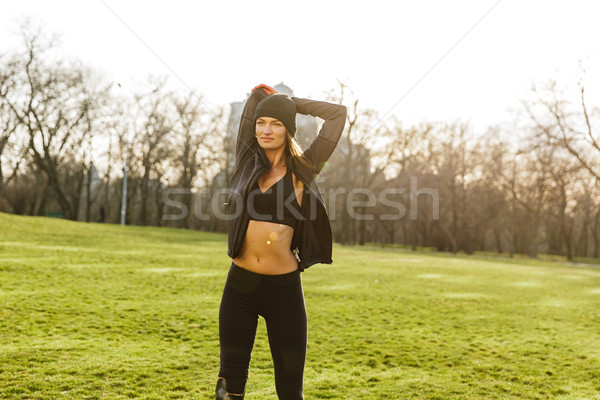 Portrait of attractive handicapped woman in black tracksuit with