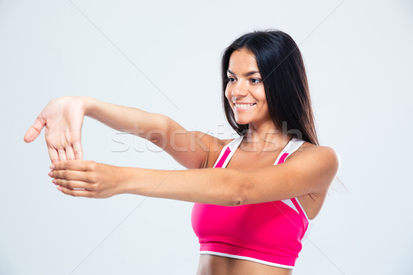 Smiling sports woman stretching fingers Stock photo © deandrobot