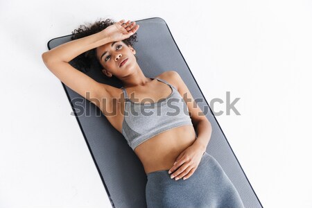 young woman flexing back muscles on bench  Stock photo © deandrobot