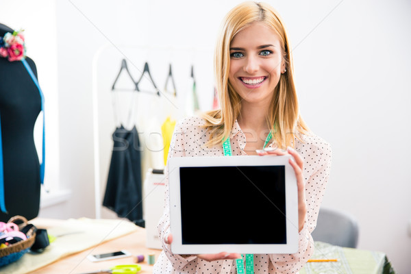 Girl showing tablet computer screen Stock photo © deandrobot