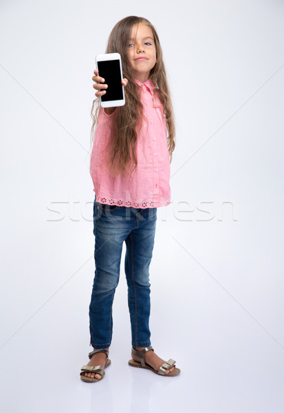 Stock photo: Little girl showing smartphone screen