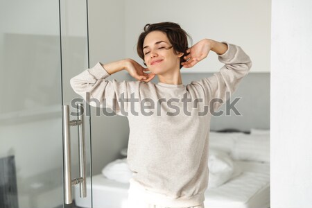 Funny cute young woman in earphones singing and dancing  Stock photo © deandrobot