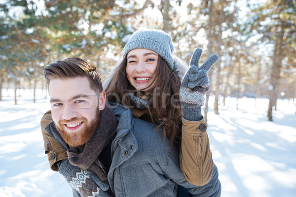 Happy couple walking in winter park Stock photo © deandrobot