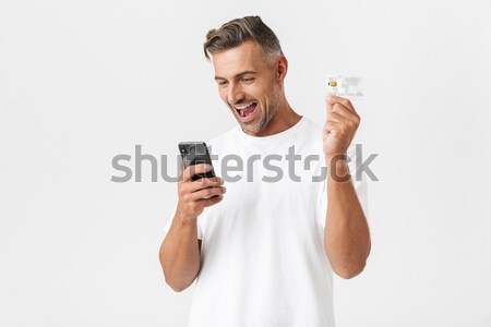 Man making selfie photo on smartphone and showing his biceps  Stock photo © deandrobot