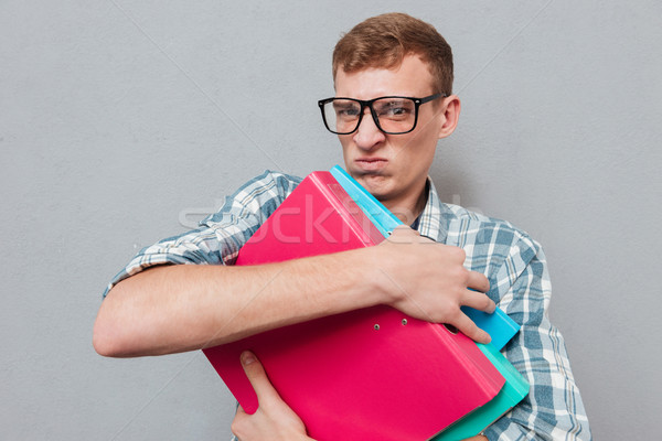 Hipster in glasses with folders Stock photo © deandrobot
