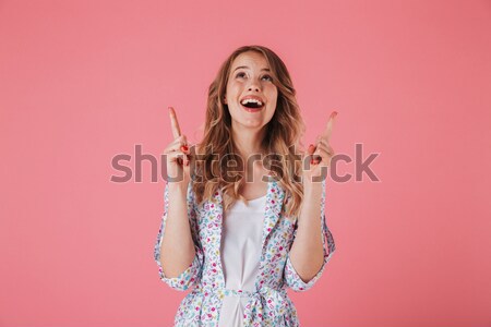Happy curly little girl smiling and talking on red telephone Stock photo © deandrobot