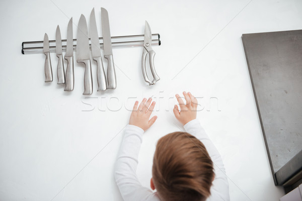 Child is trying to get a kitchen knife Stock photo © deandrobot