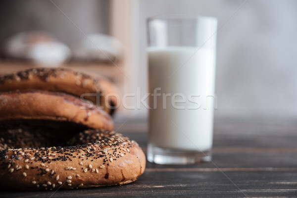 Pastries and glass of milk on dark wooden table Stock photo © deandrobot