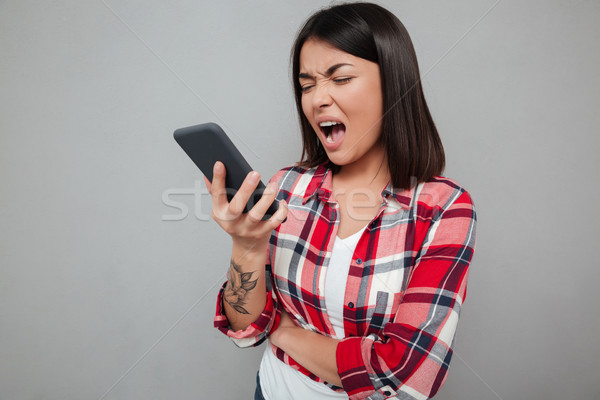 Böse jungen asian Frau isoliert Telefon Stock foto © deandrobot