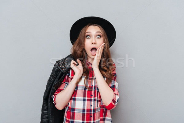 Portrait of an astonished amazed girl in plaid shirt Stock photo © deandrobot