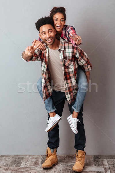 Full length portrait of a happy young african man Stock photo © deandrobot