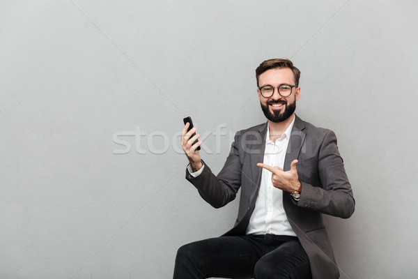 Cropped picture of happy man in eyeglasses looking on camera whi Stock photo © deandrobot